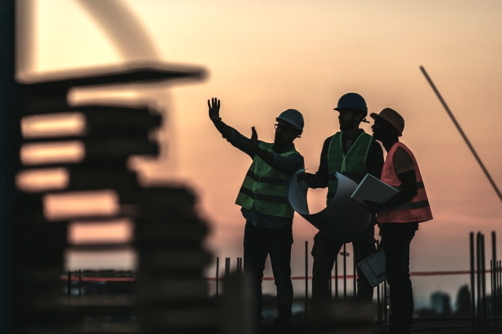 Engineers reviewing plans on a construction site to support sustainable infrastructure development